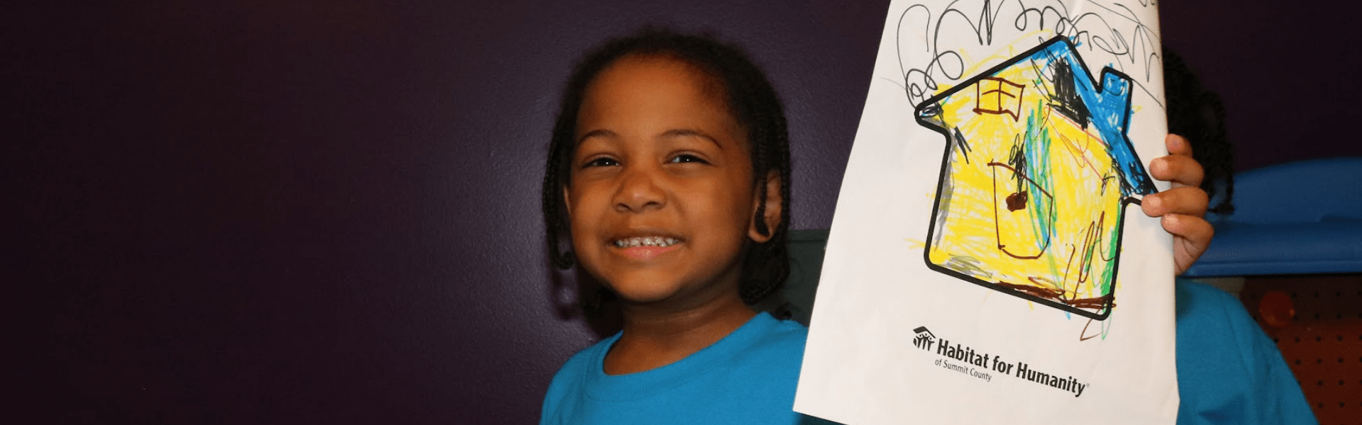 Child with Drawing Child smiling holding up hand drawn picture of future home